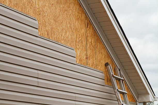 Professional Storm Damage Siding Repair technician working in Henderson, CO